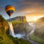 Free Online Jigsaw Puzzle – Sunrise Balloon and Waterfall Scene